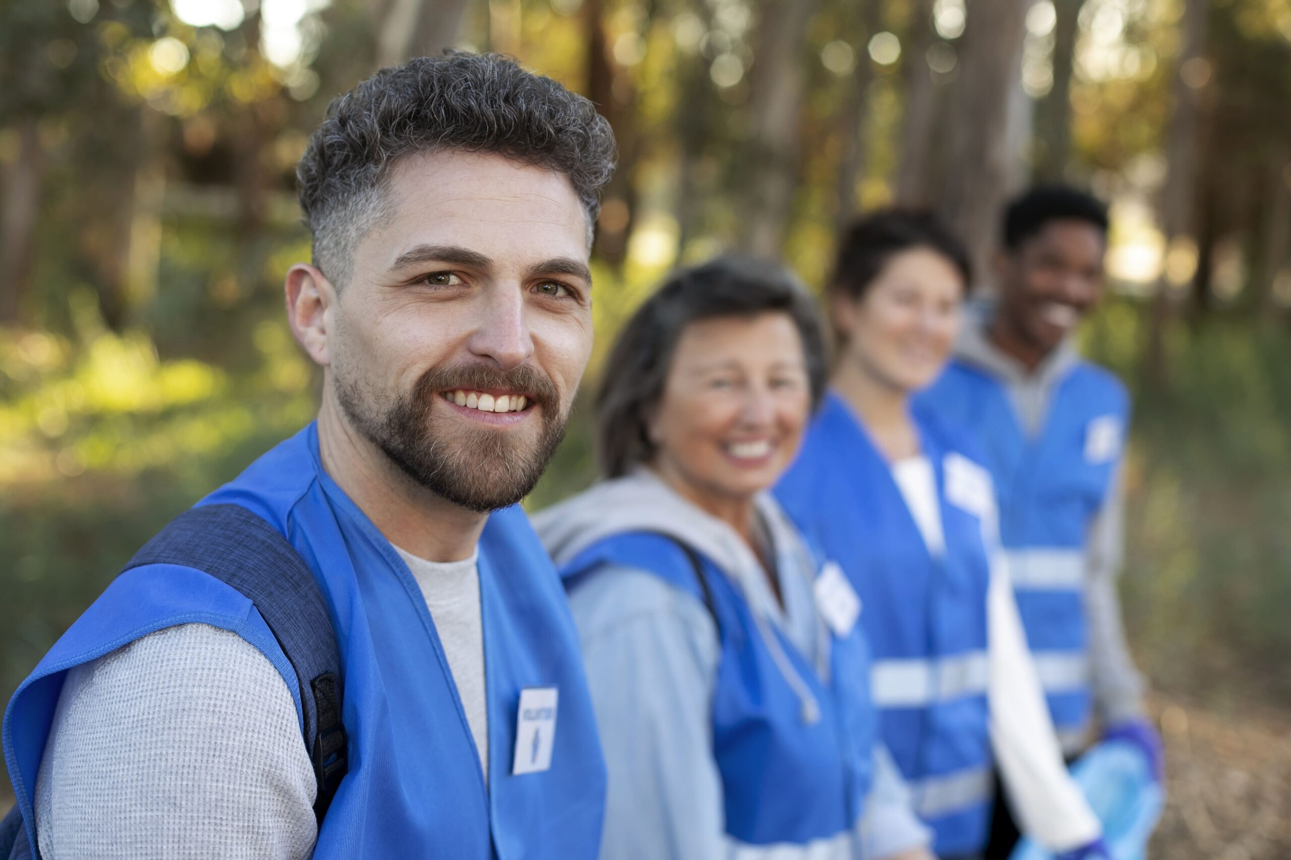 Professional immigration consultants working with a diverse family reviewing visa documents and world map in a modern consultation room