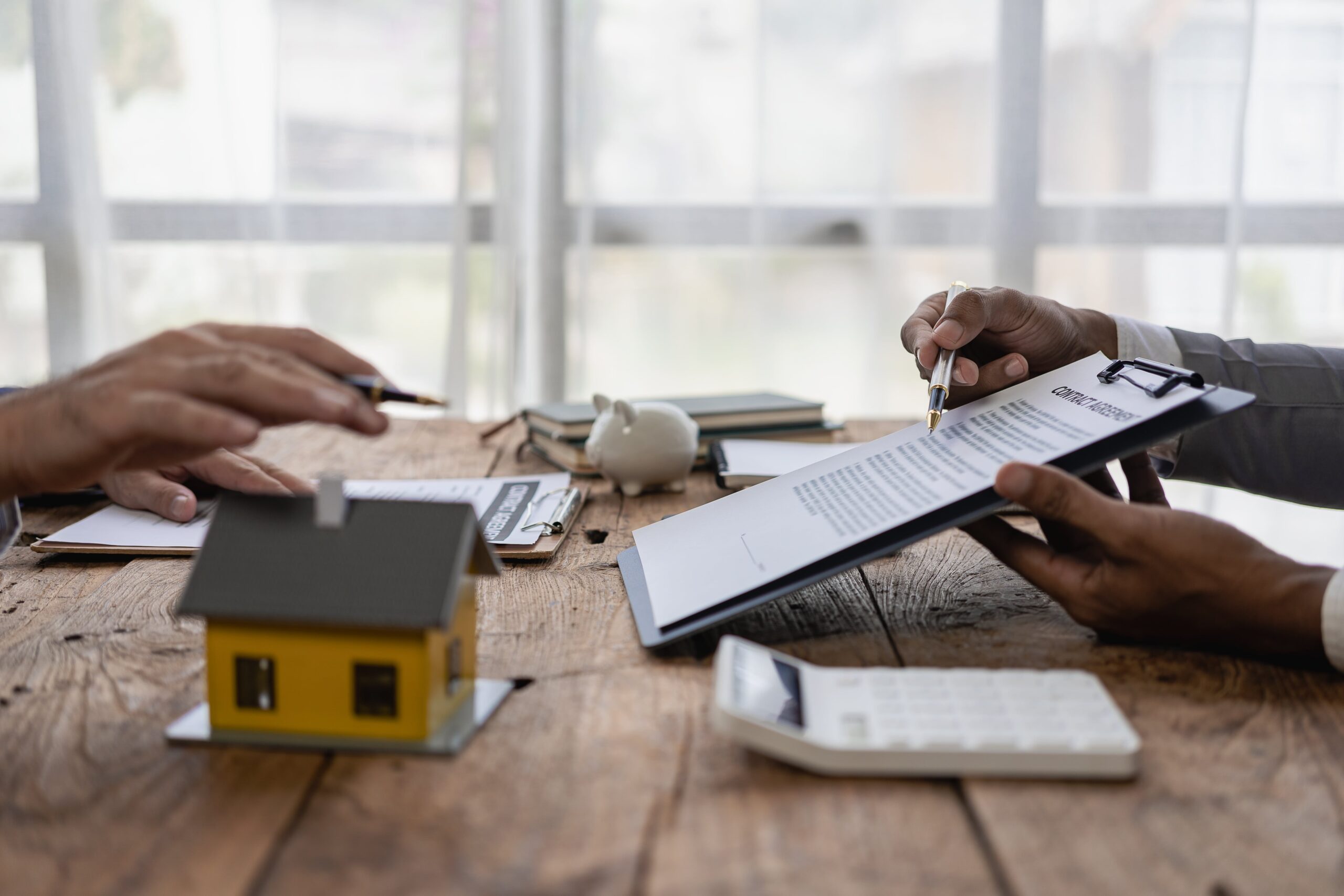 Professional immigration consultants working with a diverse family reviewing visa documents and world map in a modern consultation room